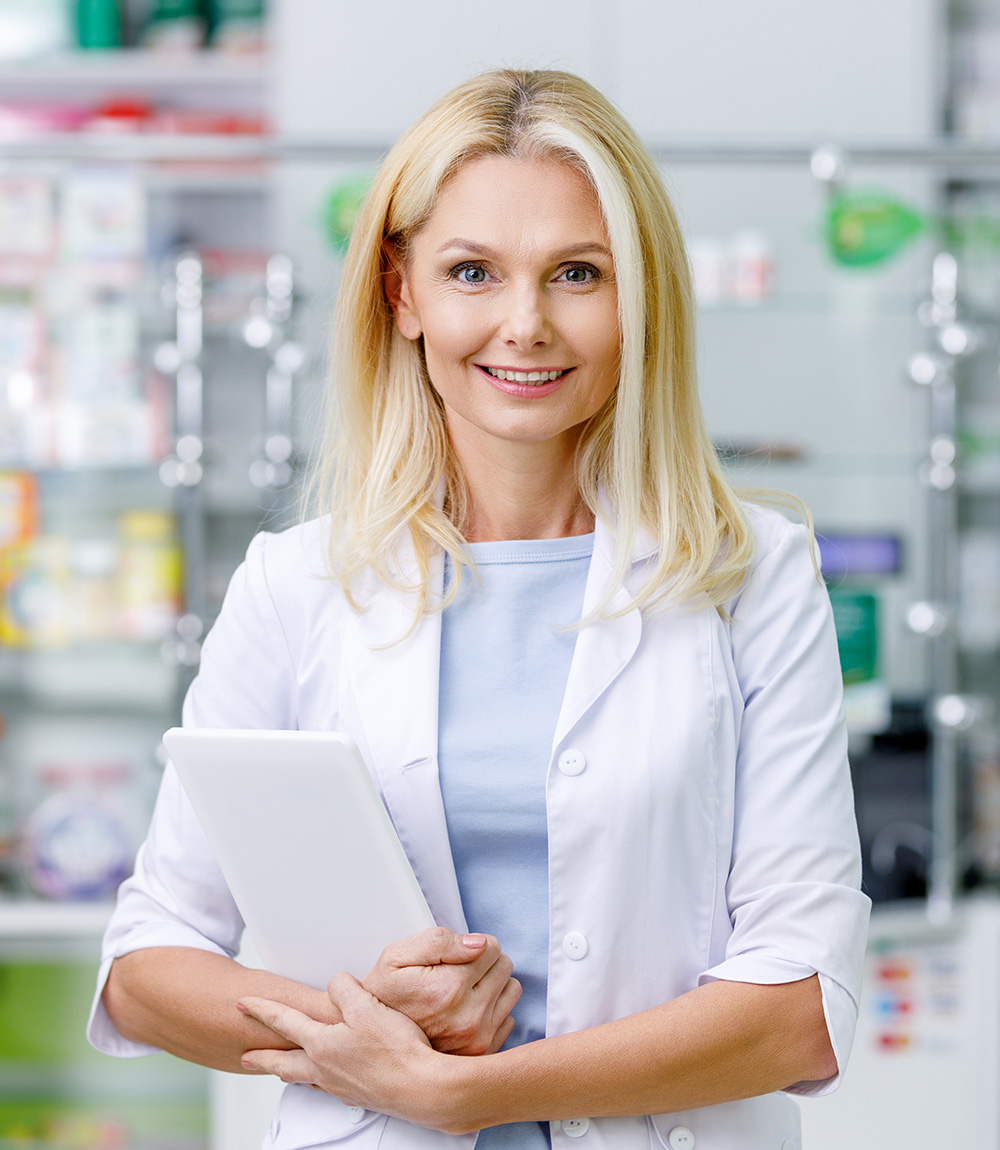 female pharmacist in white coat holding digital ta F5GU928 About Us